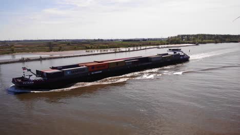 Aerial-View-Along-Port-Side-Of-Petran-Cargo-Ship-Travelling-Along-Oude-Maas