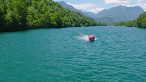 Aerial-Of-Red-Speed-Boat-Moving-Along-Puelo-River-In-Chile