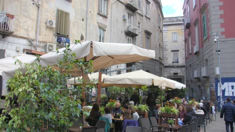 People-Hanging-Out-And-Enjoying-their-Snacks-And-Coffees-At-Piazza-Bellini-Square-In-Naples,-Italy