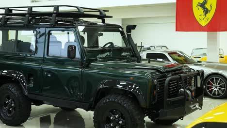 side-of-land-rover-defender-classic-moss-green-110,-british-safari-car-vintage-1990