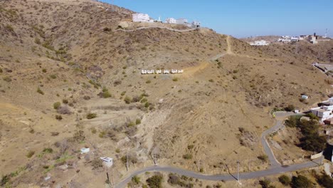 Aerial-view-towards-the-Al-baha-sign,-in-Saudi-Arabia---approaching,-drone-shot