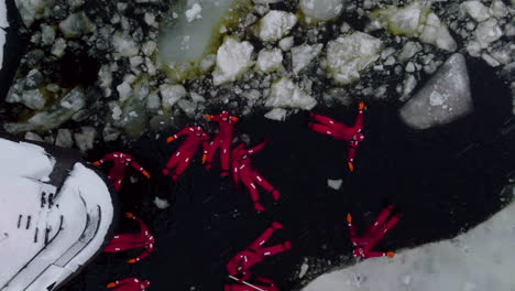 People-On-Immersion-Suit-Floating-In-The-Icy-Cold-Water-Of-Bothnian-Sea-In-Front-Of-Icebreaker-Cruise-Ship-In-Finland