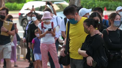 A-couple-embraces-and-supports-each-other-as-mourners-gather-outside-the-British-Consulate-General-as-they-pay-tribute-after-the-passing-of-the-former-and-longest-serving-monarch-Queen-Elizabeth-II