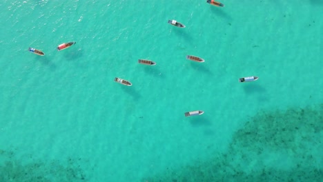 Nungwi-Beach,-Zanzibar---Tanzania---June-18,-2022---Boats-on-the-Indian-ocean-on-a-sunny-cloudy-day-during-sunrise