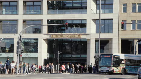 People-crossing-the-street-in-front-of-Europa-Passage-Hamburg,-Germany