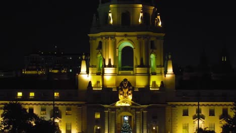 Establishing-view-of-Pasadena-City-Hall-at-night-during-Christmas-Holiday-Season,-rising-aerial-view