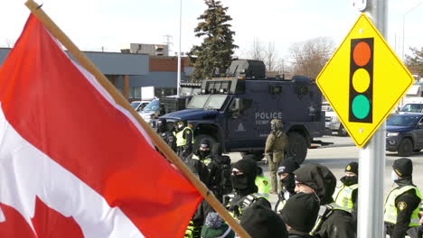 Policemen-in-riot-gear-and-trucks-in-the-street