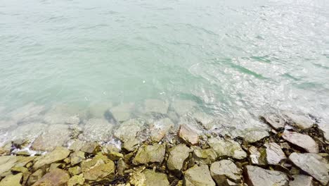 A-static-shot-taken-from-the-shore-where-we-can-see-small-tides-hitting-the-rocks