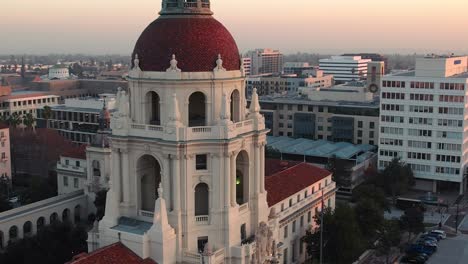 Facade-aerial-rising-of-City-Hall-in-Pasadena,-California-during-sunset,-cinematic-establishing-view