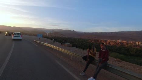 Point-of-view-of-a-driver-going-next-to-the-Tineghir-palm-grove-on-his-way-to-the-Todgha-gorges,-Morocco