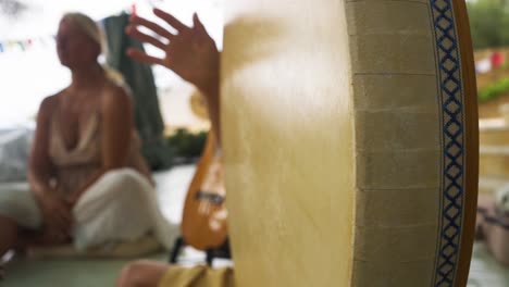 View-Of-Hand-Drumming-On-Shamanic-Drum-At-Yoga-Retreat