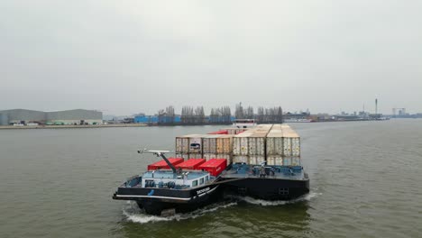 29-January-2023---Aerial-View-Of-Denford-Cargo-Ship-Partnered-With-Barge-Transporting-Containers-Along-Oude-Maas