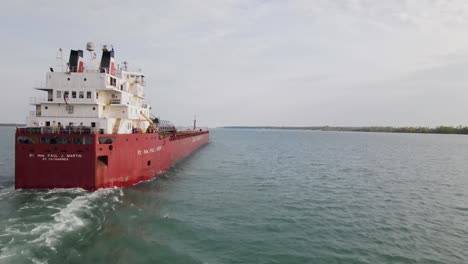 Freighter-on-the-Detroit-River-near-Wyandotte-Michigan,-aerial-follow-shot