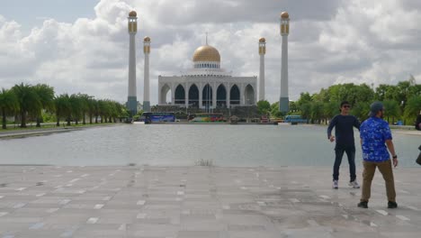 Shot-of-a-group-of-locals-posing-in-front-of-Central-Mosque-in-Songkhla-province,-Southern-of-Thailand-at-daytime