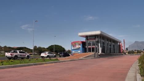 Long-articulated-transit-bus-pulls-up-to-Racecourse-bus-stop,-Cape-town