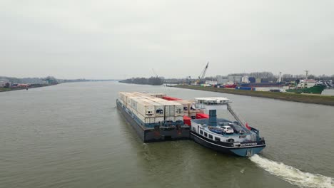 29-January-2023---Aerial-Strern-View-Of-Denford-Cargo-Ship-Partnered-With-Barge-Transporting-Containers-Along-Oude-Maas