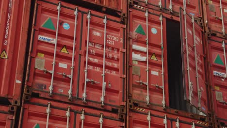 Panning-shot-of-many-industrial-shipping-container-stacked-on-harbor-in-Le-Havre