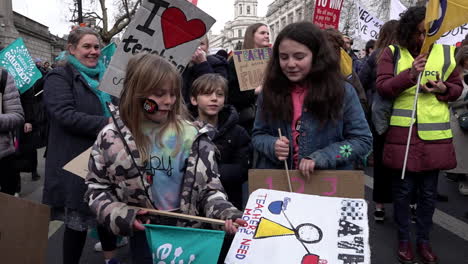 Three-children-holding-placards-join-in-chants-on-the-National-Education-Union-national-strike-protest-in-slow-motion