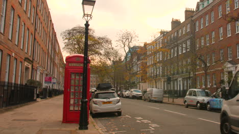 Classic-Red-Phonebooth-On-The-Urban-Road-Streets-In-London,-United-Kingdom