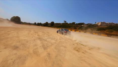 Fantastische-FPV-Luftaufnahme-Eines-Schwarzen-BMW,-Der-Im-Sand-Driftet