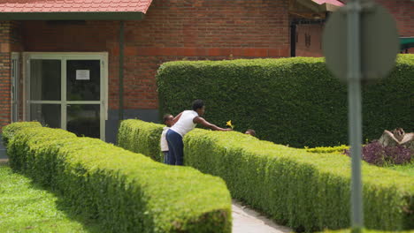 Mother-and-kids-walk-outside-of-hospital-in-Rwanda