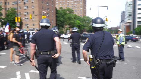 New-York-Police-Officers-in-Riot-Gear-with-Batons-walking-into-Crowd-of-Protestors-during-Black-Lives-Matter-protest-in-Brooklyn,-New-York-City