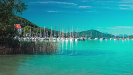 View-of-the-small-sailing-boat-harbor-at-Lake-Wörthersee-near-Klagenfurt,-Carinthia,-Austria-on-a-nice-and-sunny-day