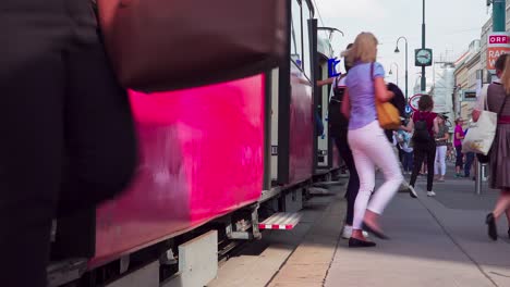 Doors-are-opening-and-people-are-getting-on-and-off-a-tram-on-Opernring-in-Vienna