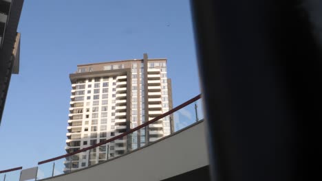 Looking-Up-With-Slow-Pan-Left-View-Across-Pole-And-Balcony-With-View-Of-Emaar-Residential-Apartments-In-Karachi