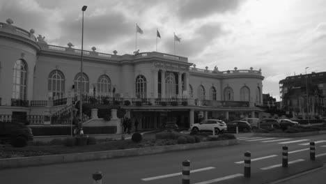 Cars-Driving-In-The-Road-In-Front-Of-Deauville-Casino-In-Normandy,-France