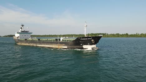 Freighter-sailing-on-Detroit-river,-aerial-close-flying-view