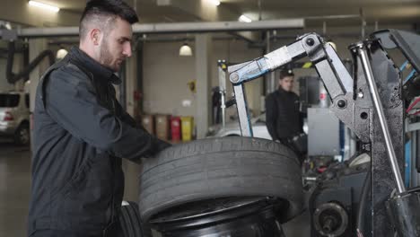 A-mechanic-uses-a-tire-iron-in-his-garage