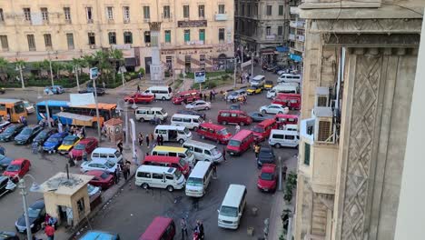 High-Traffic-of-Buses,-Cars,-Motorcycles,-Taxis,-and-Pedestrians-in-the-Ancient-City-of-Alexandria-in-Egypt