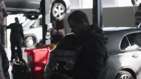 A-Métis-mechanic-receives-a-screwdriver-from-his-co-worker