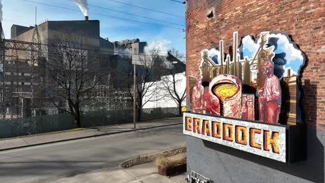 Braddock,-Pennsylvania-sign-with-USS-Steel-manufacturing-mill-in-background