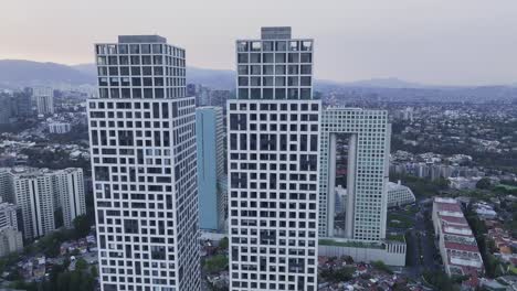 Aerial-view-around-the-Arcos-Bosques-de-las-Lomas-towers,-vibrant-morning-in-Mexico-city