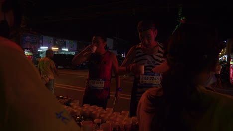 Runners-doing-a-water-break-during-the-Samui-Run-on-Koh-Samui-Island