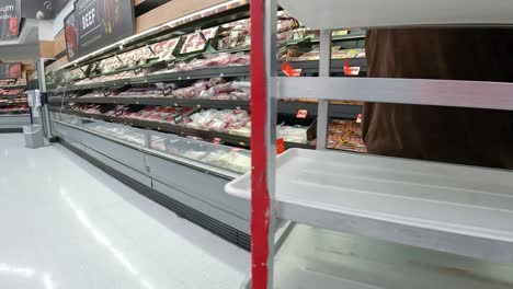 Empleado-Que-Reabastece-Las-Pantallas-De-Carne-En-Una-Tienda-De-Comestibles-Estadounidense