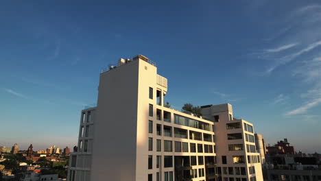 Aerial-view-in-front-of-the-sunlit-Saint-Marks-Place-residence,-in-Brooklyn,-NY,-USA---Ascending,-tilt,-drone-shot