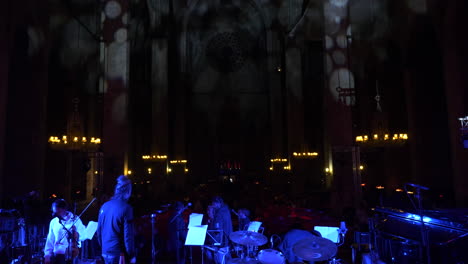 Back-view-of-group-concert-in-Cathedral-of-Barcelona,-static-view