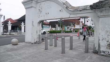 Hijab-woman-walking-on-a-sidewalk-of-main-street-at-Zero-point-kilometer-of-Yogyakarta