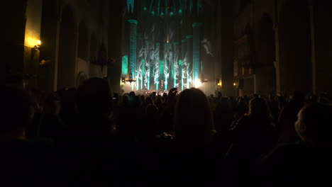 Silueta-De-Personas-De-Pie-Y-Aplaudiendo-En-Un-Concierto-En-La-Catedral-De-Barcelona,-Vista-Trasera