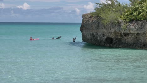 People-bathing-in-the-blue-ocean-and-lady-walking-in-the-water