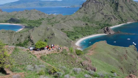 Groups-of-tourist-gathering-at-popular-panoramic-view-lookout-on-tropical-Padar-Island-in-Komodo-National-Park,-East-Nusa-Tenggara,-Indonesia