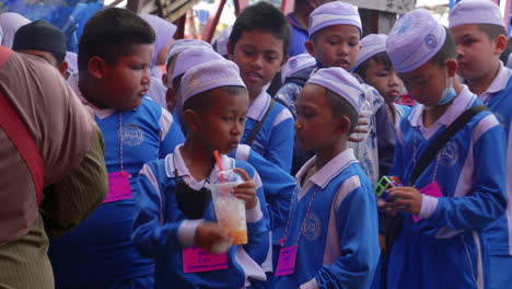 Muslim-boys-in-school-uniforms-drinking-smoothies-on-a-school-trip-in-Thailand