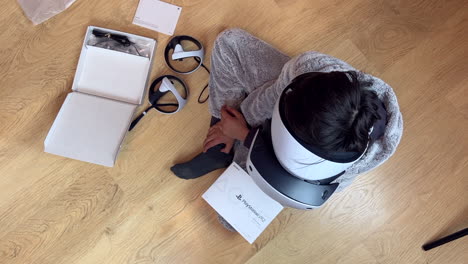 A-boy-unboxing-and-setting-up-the-Sony-PS5-VR2-virtual-reality-headset