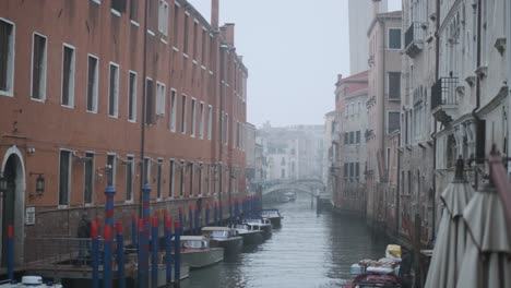 Stationary-shot-of-large-quiet-Venetian-canal-on-a-foggy-day