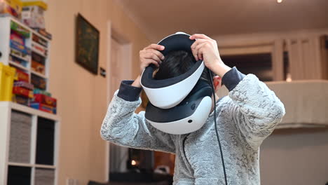 A-boy-unboxing-and-setting-up-the-Sony-PS5-VR2-virtual-reality-headset