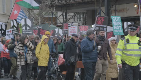 Peace-Protesters-Marching-through-Central-London-on-February-25th-2023-with-Banners-and-Flags-in-Opposition-to-the-War-in-Ukraine-and-the-Russian-Invasion