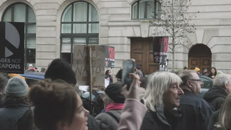 Stop-the-War-in-Ukraine-Protesters-with-Placards,-Gathering-Before-Marching-in-Central-London-on-February-26th-2023,-No-to-War,-No-to-Nato-Demonstration